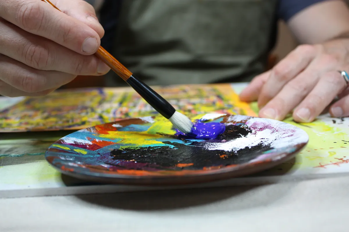 Painting at the studio table.